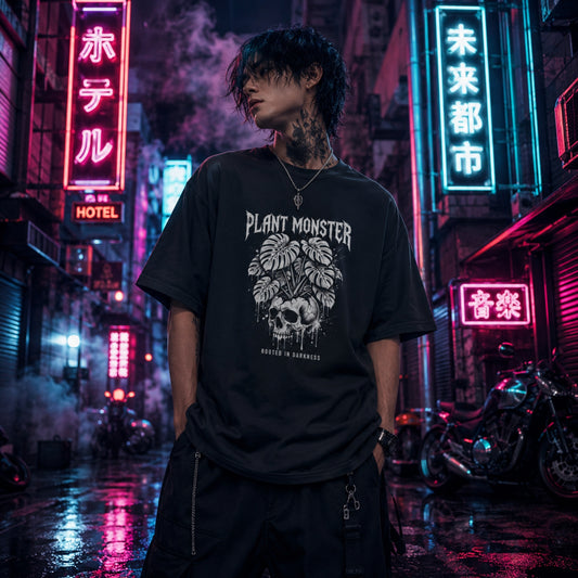 Person wearing a black oversized t-shirt with a graphic design in a neon-lit urban street'plant monster'
