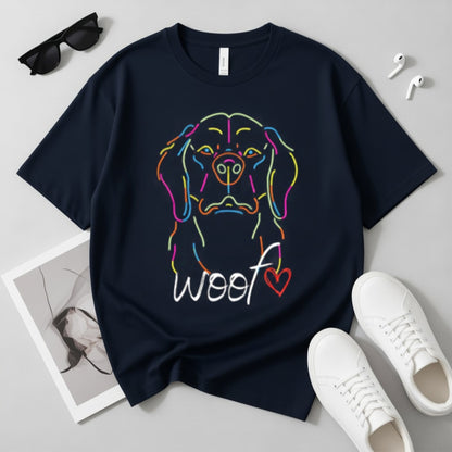 Navy blue oversized t-shirt with colorful dog graphic and 'woof' text on a light gray surface with accessories.